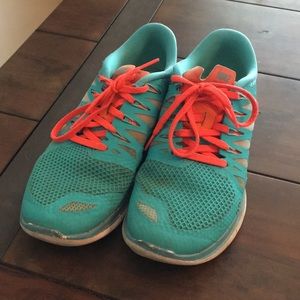 Teal/orange Nike Free running shoes
